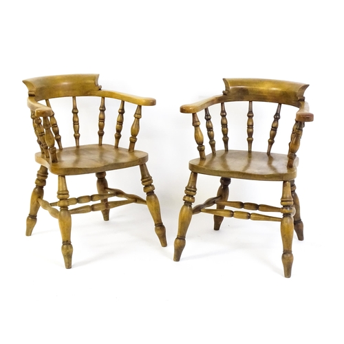 1682 - A pair of mid / late 20thC smokers bow chairs / captains chairs, with bowed backs, turned supports, ... 