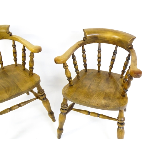 1682 - A pair of mid / late 20thC smokers bow chairs / captains chairs, with bowed backs, turned supports, ... 