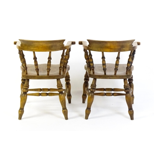 1682 - A pair of mid / late 20thC smokers bow chairs / captains chairs, with bowed backs, turned supports, ... 