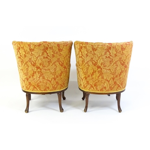 1685 - A pair of mid 20thC barrel back armchairs raised on acanthus carved cabriole legs terminating in car... 