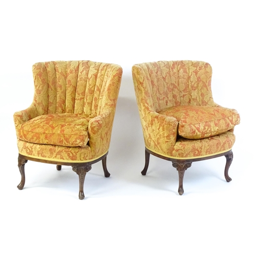 1685 - A pair of mid 20thC barrel back armchairs raised on acanthus carved cabriole legs terminating in car... 