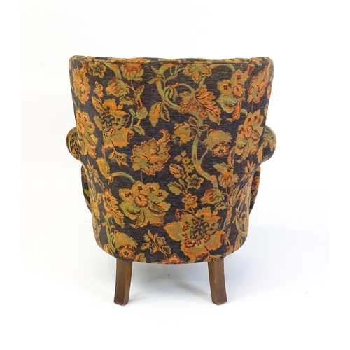 1688 - A mid 20thC barrel back armchair with scrolled arms, sprung seat and raised on cabriole front legs. ... 