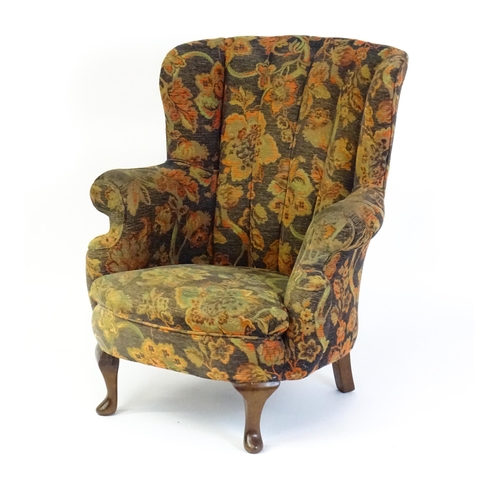 1688 - A mid 20thC barrel back armchair with scrolled arms, sprung seat and raised on cabriole front legs. ... 