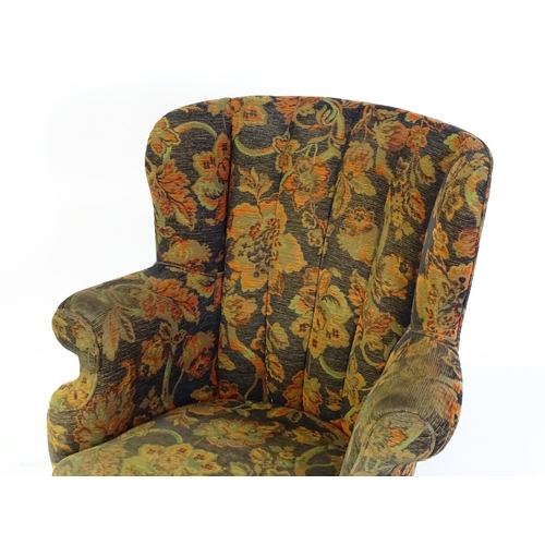 1688 - A mid 20thC barrel back armchair with scrolled arms, sprung seat and raised on cabriole front legs. ... 