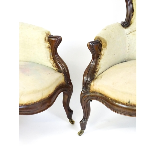 1690 - A pair of 19thC mahogany armchairs for re-upholstery, the chairs having spoon backs, manchettes and ... 