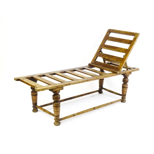 1704 - A late 19thC 'Leveson & Sons' campaign bed /day bed with a slatted bed and adjustable headrest above... 