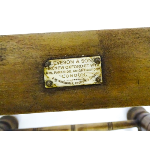 1704 - A late 19thC 'Leveson & Sons' campaign bed /day bed with a slatted bed and adjustable headrest above... 