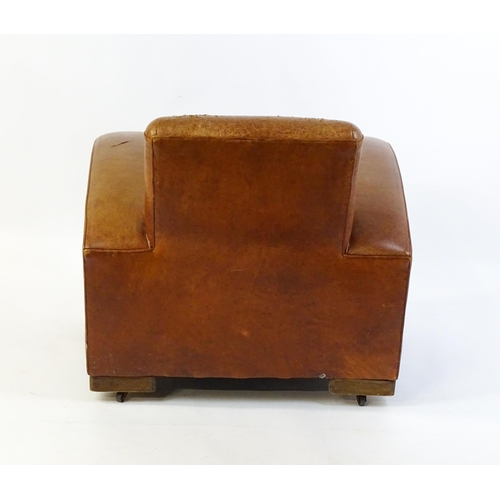 1707 - An early / mid 20thC Art Deco style leather club chair raised on block feet terminating in castors. ... 