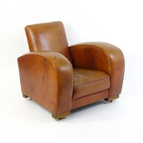 1707 - An early / mid 20thC Art Deco style leather club chair raised on block feet terminating in castors. ... 