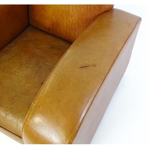 1707 - An early / mid 20thC Art Deco style leather club chair raised on block feet terminating in castors. ... 