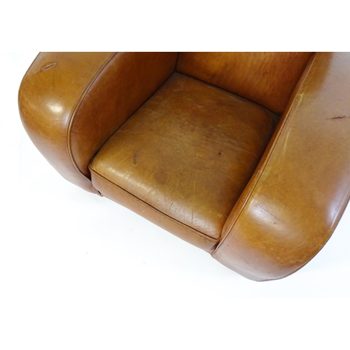 1707 - An early / mid 20thC Art Deco style leather club chair raised on block feet terminating in castors. ... 