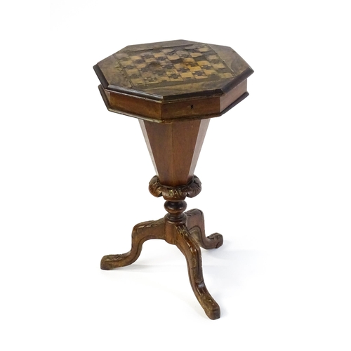 1710 - A 19thC trumpet shaped walnut sewing table with an octagonal hinged top inlaid with a games board, t... 