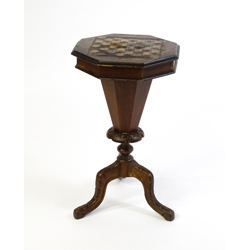 1710 - A 19thC trumpet shaped walnut sewing table with an octagonal hinged top inlaid with a games board, t... 