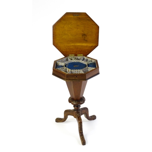 1710 - A 19thC trumpet shaped walnut sewing table with an octagonal hinged top inlaid with a games board, t... 