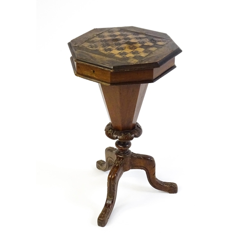 1710 - A 19thC trumpet shaped walnut sewing table with an octagonal hinged top inlaid with a games board, t... 