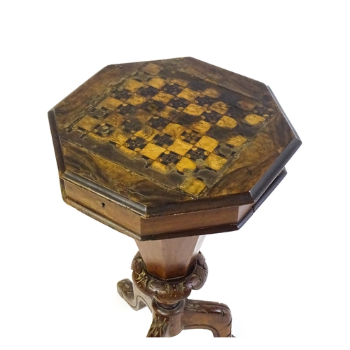 1710 - A 19thC trumpet shaped walnut sewing table with an octagonal hinged top inlaid with a games board, t... 