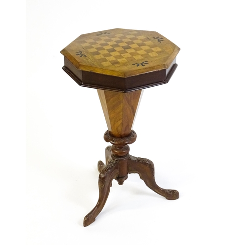 1713 - A 19thC trumpet shaped walnut sewing table with an octagonal hinged top inlaid with a games board, t... 