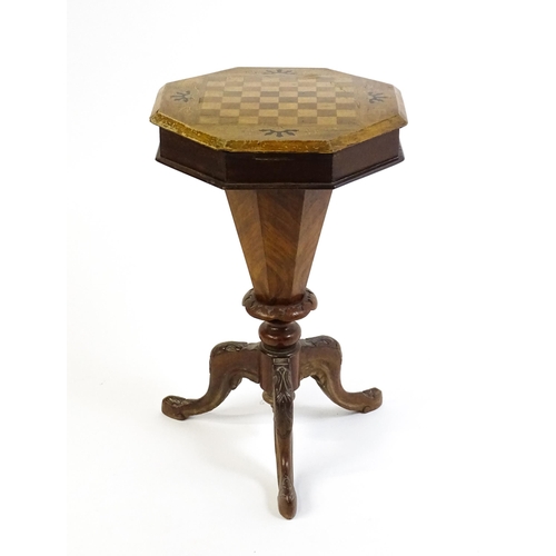 1713 - A 19thC trumpet shaped walnut sewing table with an octagonal hinged top inlaid with a games board, t... 