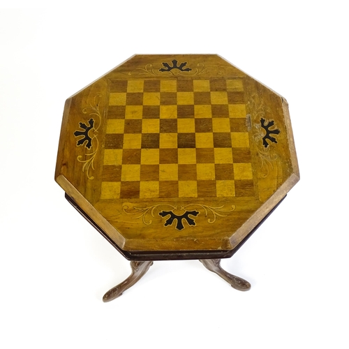 1713 - A 19thC trumpet shaped walnut sewing table with an octagonal hinged top inlaid with a games board, t... 