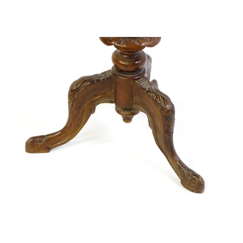 1713 - A 19thC trumpet shaped walnut sewing table with an octagonal hinged top inlaid with a games board, t... 