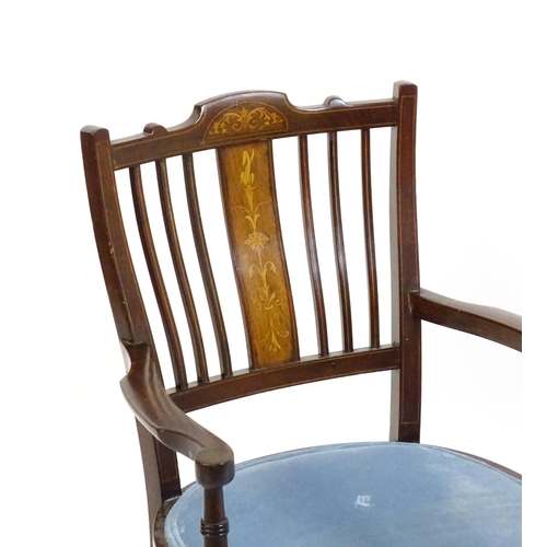 1715 - An Edwardian mahogany side chair with satinwood marquetry decoration, swept arms and raised on inlai... 