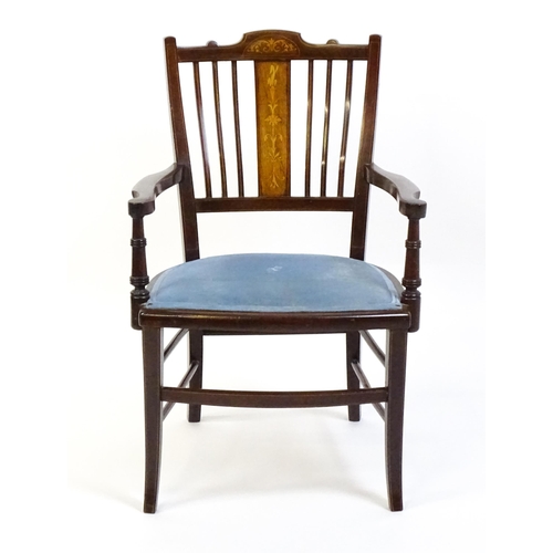 1715 - An Edwardian mahogany side chair with satinwood marquetry decoration, swept arms and raised on inlai... 