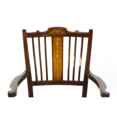 1715 - An Edwardian mahogany side chair with satinwood marquetry decoration, swept arms and raised on inlai... 