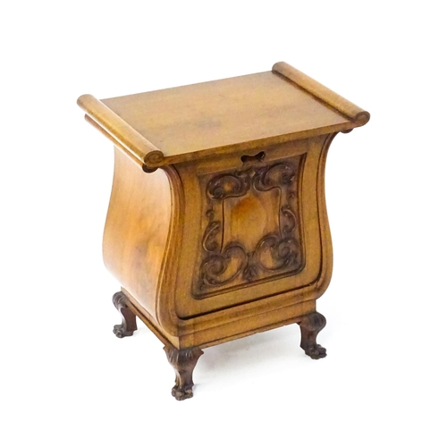 1753 - An early 20thC walnut side table with a hinged lid and a floral carved front raised on carved cabrio... 