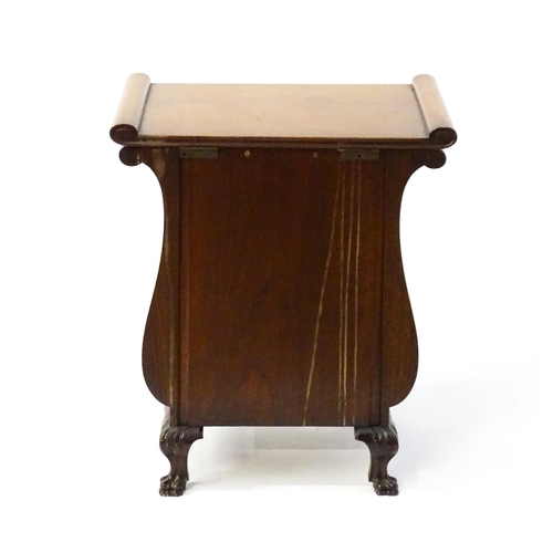 1753 - An early 20thC walnut side table with a hinged lid and a floral carved front raised on carved cabrio... 