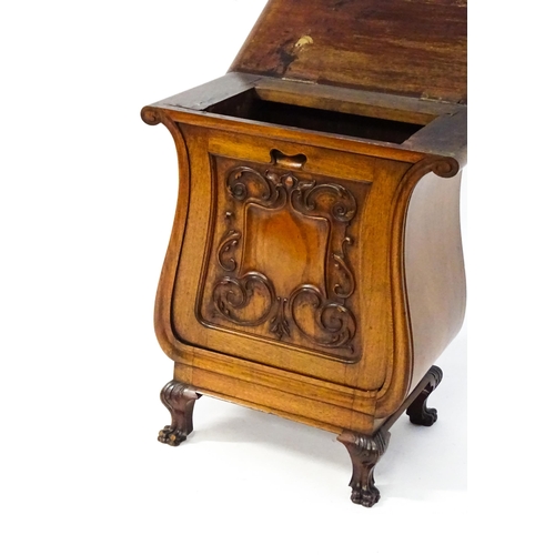 1753 - An early 20thC walnut side table with a hinged lid and a floral carved front raised on carved cabrio... 