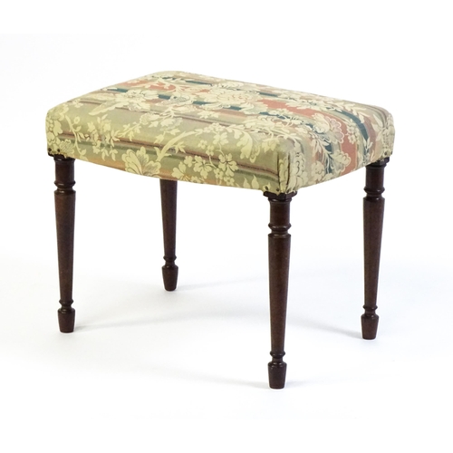 1755 - A late 18thC / early 19thC stool with an upholstered top above four turned tapering legs. 21