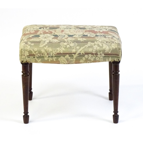 1755 - A late 18thC / early 19thC stool with an upholstered top above four turned tapering legs. 21