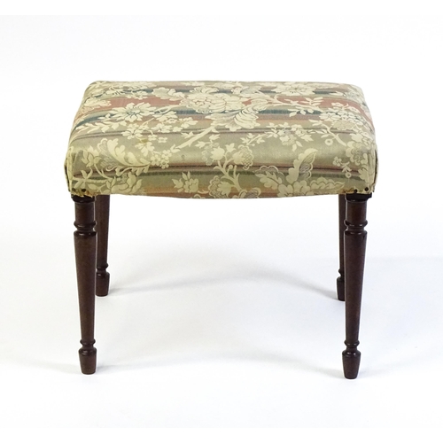 1755 - A late 18thC / early 19thC stool with an upholstered top above four turned tapering legs. 21