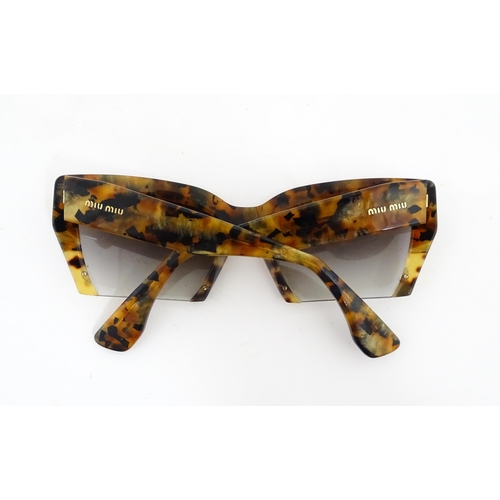 1094 - Vintage fashion / clothing: A pair of Miu Miu tortoiseshell rasoir cutoff rimless bottom sunglasses,... 