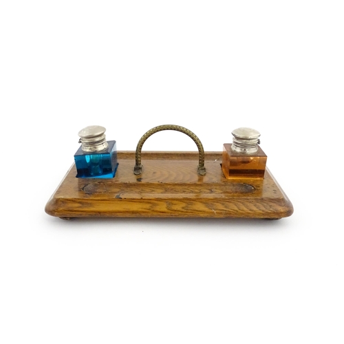 1210A - A Victorian oak standish with two coloured glass inkwells and two pen wells. Together with an onyx s... 