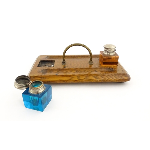 1210A - A Victorian oak standish with two coloured glass inkwells and two pen wells. Together with an onyx s... 