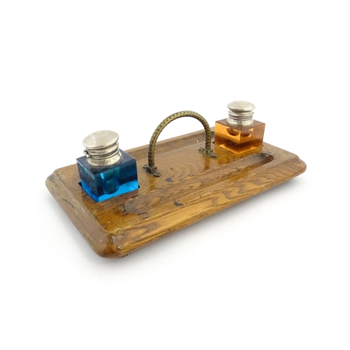 1210A - A Victorian oak standish with two coloured glass inkwells and two pen wells. Together with an onyx s... 