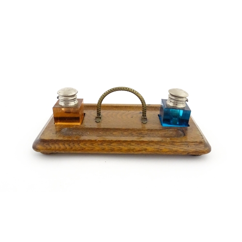 1210A - A Victorian oak standish with two coloured glass inkwells and two pen wells. Together with an onyx s... 