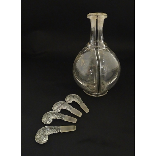 202 - An early 20thC four sectional glass liqueur / liquor decanter having four fleur de lys / feather plu... 