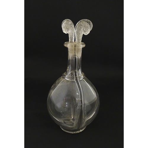 202 - An early 20thC four sectional glass liqueur / liquor decanter having four fleur de lys / feather plu... 