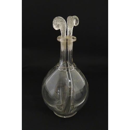 202 - An early 20thC four sectional glass liqueur / liquor decanter having four fleur de lys / feather plu... 