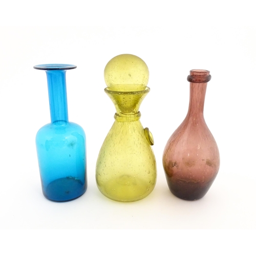 220A - Three items of glassware to include a turquoise glass bottle vase, a purple glass bottle vase and a ... 