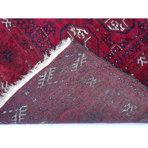 1505 - Carpet / Rug : A red ground rug decorated with repeating geometric motifs. Approx. 75