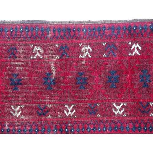 1505 - Carpet / Rug : A red ground rug decorated with repeating geometric motifs. Approx. 75