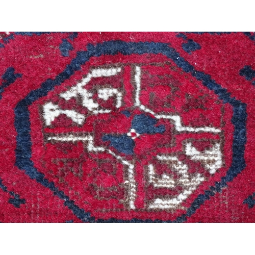 1505 - Carpet / Rug : A red ground rug decorated with repeating geometric motifs. Approx. 75