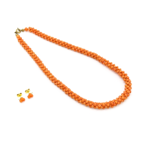 783 - A coral bead necklace. Together with a pair of 9ct gold stud earrings set with coral beads. Necklace... 