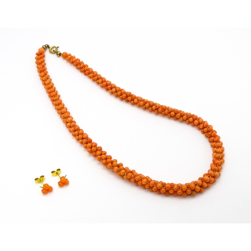 783 - A coral bead necklace. Together with a pair of 9ct gold stud earrings set with coral beads. Necklace... 