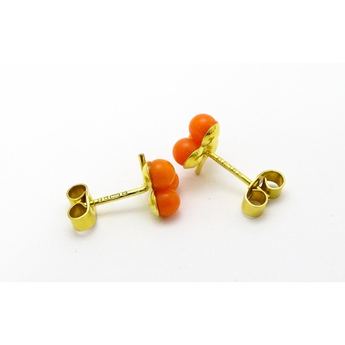 783 - A coral bead necklace. Together with a pair of 9ct gold stud earrings set with coral beads. Necklace... 