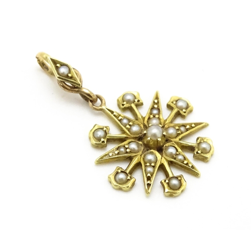 784 - A Victorian 15ct gold pendant of star form set with seed pearls, and engraved 'N' to reverse. Approx... 