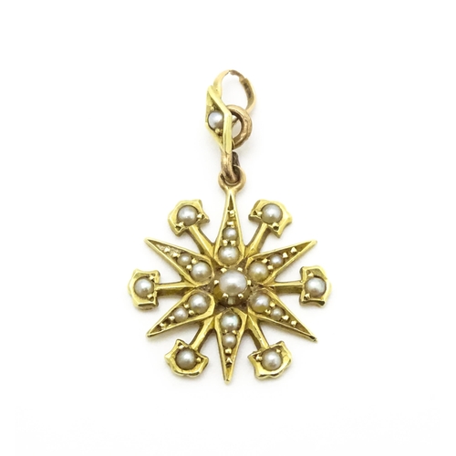 784 - A Victorian 15ct gold pendant of star form set with seed pearls, and engraved 'N' to reverse. Approx... 